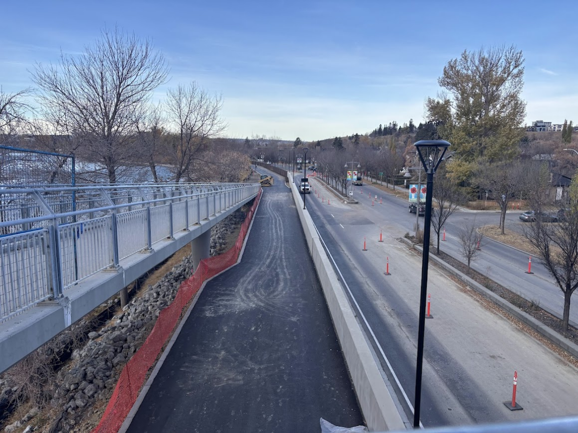Photo of a walking and cycling pathway along the Bow River and Memorial Drive, north of Prince's Island Park